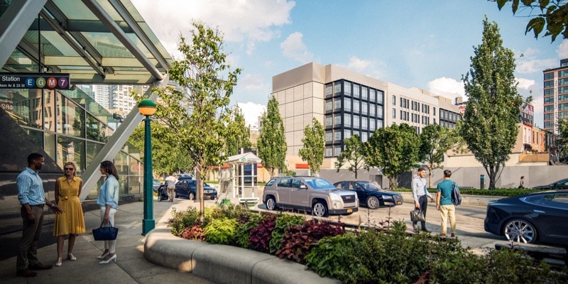 Zoomed out view from Innolabs entrance with visible bus lines and people conversing around the area