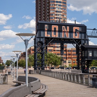 Thumbnail of black industrial building in Long island along a pedestrian walkway