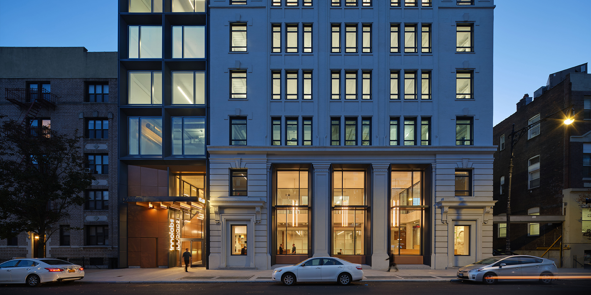 Exterior nighttime sidewalk view of the entrance to Innolabs