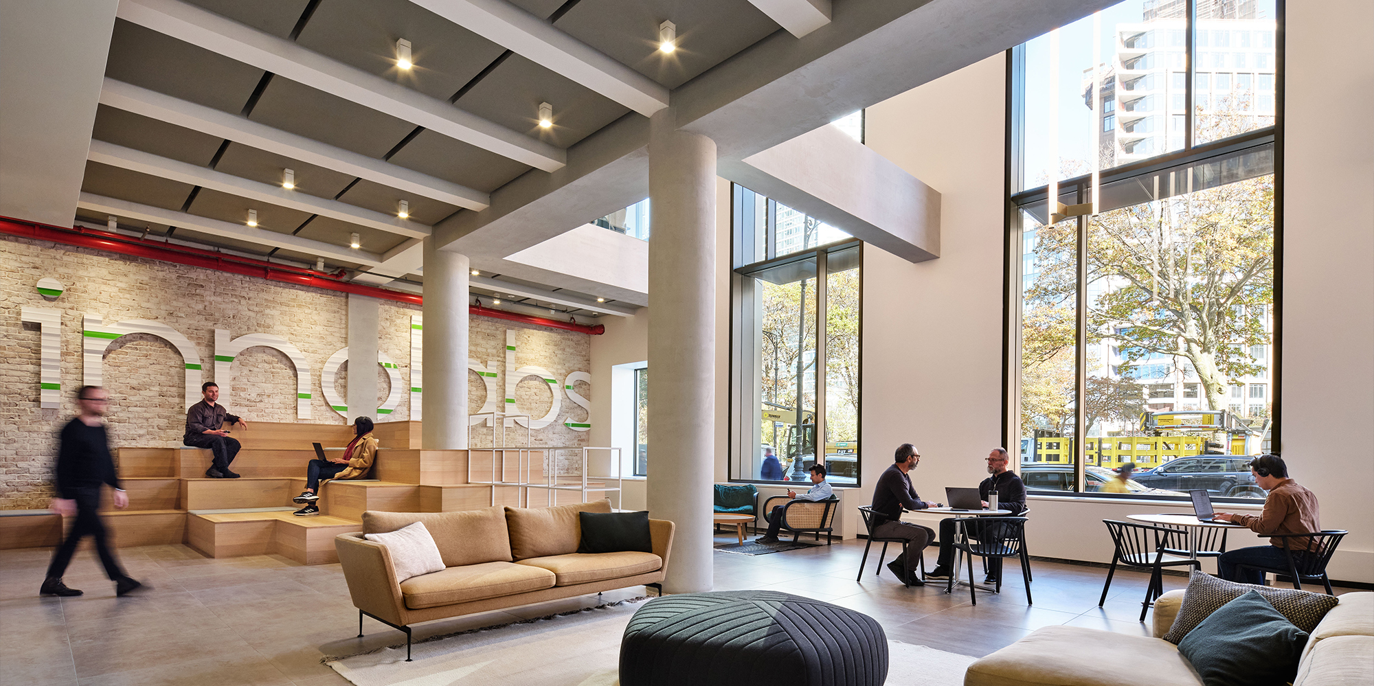 Ground floor common area with people enjoying multiple seating options